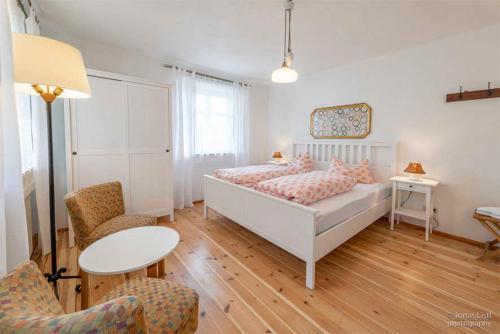 a bedroom with a bed and a table and chairs at Landurlaub Wittmann in Pegnitz