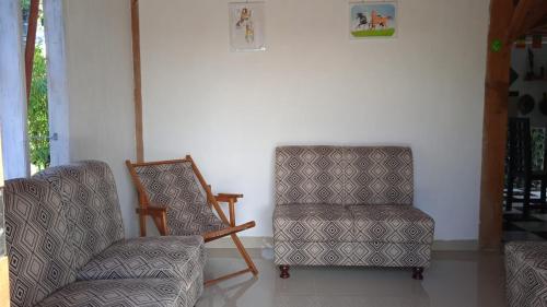a room with two chairs and a picture on the wall at THE SINGKI HOME FAMILY in Rantepao