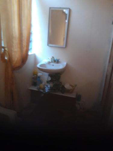 a bathroom with a sink and a mirror at Cocoa Cabana in Scarborough