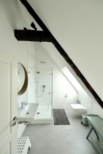 a white bathroom with a sink and a shower at Hausdeich in Hamburg