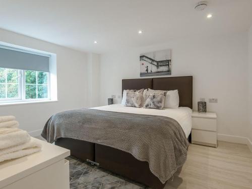 a white bedroom with a large bed and a window at The Norfolk-uk41442 in Brandon