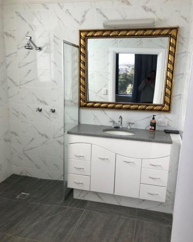 a bathroom with a sink and a mirror at Hatchers Richmond Manor in Richmond
