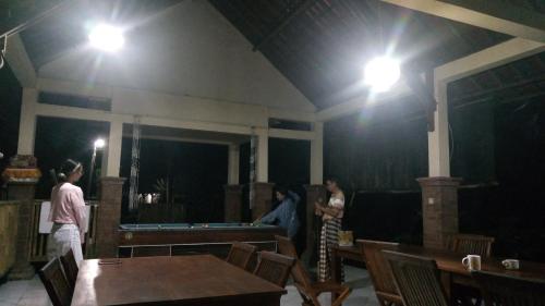 a group of people in a room with a pool table at Tegal Jero Homestay in Jatiluwih
