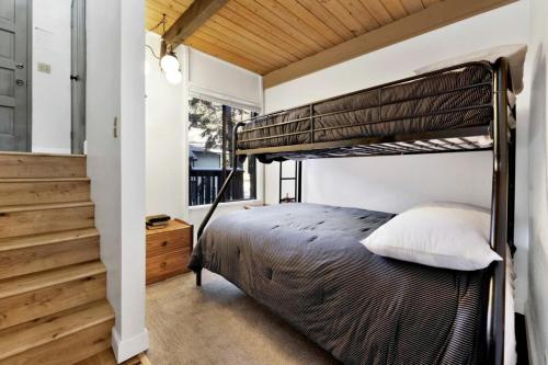 a bedroom with a bunk bed and a staircase at Switzerland Slopes #2125 by Big Bear Vacations in Big Bear Lake