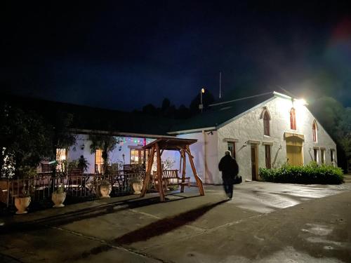 a man walking in front of a church at night at Hatchers Richmond Manor in Richmond
