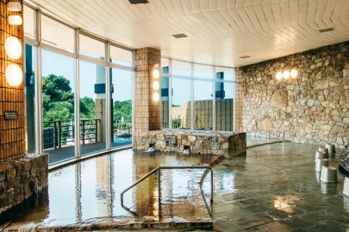 a room with a pool of water in a building at KAMENOI HOTEL Genkainada in Kitakyushu