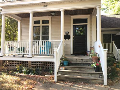 a house with a porch with two chairs on it at The Lodge Dog and Family Friendly 5 Bedrooms 13 guests 10 beds in Saint Peter