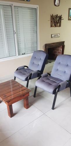 2 sillas y mesa de centro en una habitación en Casa costa chica en Las Toninas