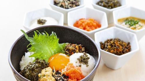 a bowl of food on a table with other dishes at Kyukamura Nyuto-Onsenkyo in Senboku