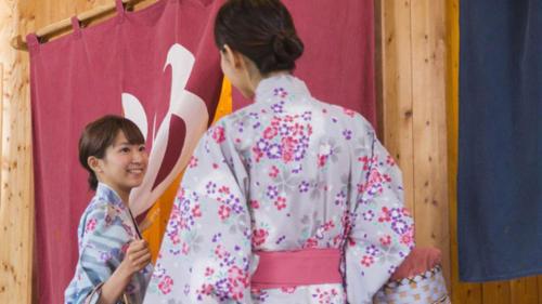 a woman in a kimono standing next to a child at Kyukamura Nyuto-Onsenkyo in Senboku