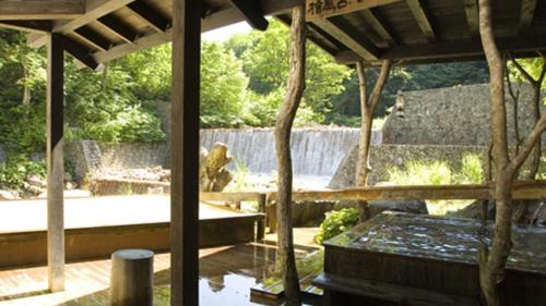 a pavilion with a pond in a zoo at Kyukamura Nyuto-Onsenkyo in Senboku