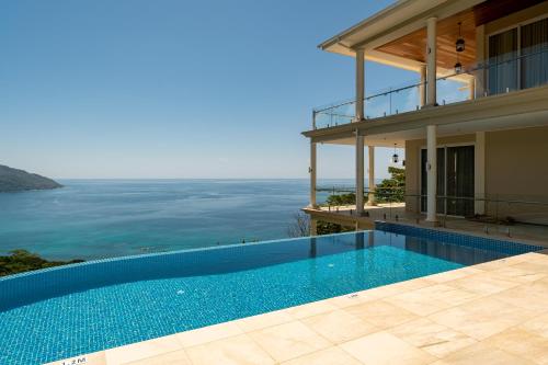 a house with a swimming pool next to the ocean at Sorento Sur Mer in Victoria