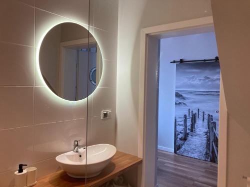 a bathroom with a sink and a mirror at Holiday house with swimming pool for 7 people in Swinoujscie in Świnoujście