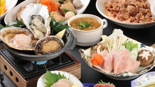 a table topped with bowls of food and bowls of soup at Kyukamura Kesennuma-Ohshima in Kesennuma