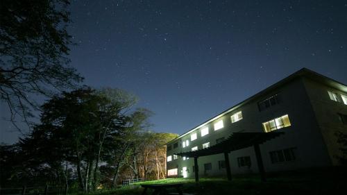 a building at night with the stars in the sky at Kyukamura Kesennuma-Ohshima in Kesennuma