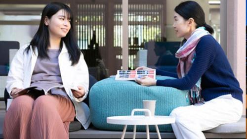 two women sitting next to each other on a bench at Kyukamura Kesennuma-Ohshima in Kesennuma