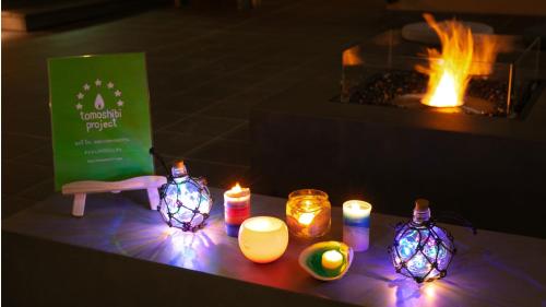 a group of candles sitting on a table with a fireplace at Kyukamura Kesennuma-Ohshima in Kesennuma