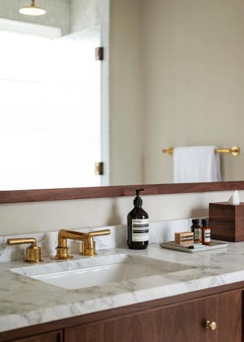 a bathroom counter with a sink and a mirror at The Pinch Charleston in Charleston