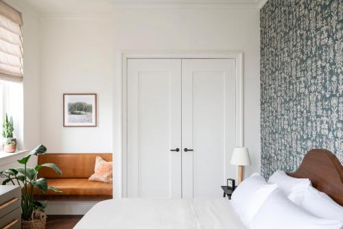 a bedroom with a bed and a couch at The Pinch Charleston in Charleston