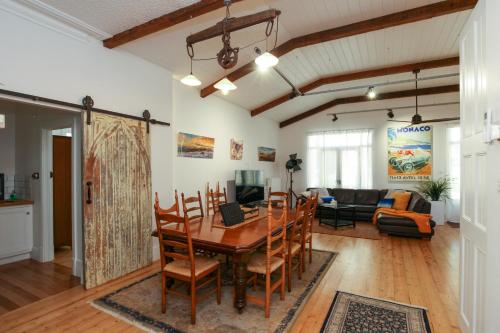 a dining room and living room with a table and chairs at Vintage Charm On St Leonards in Healesville