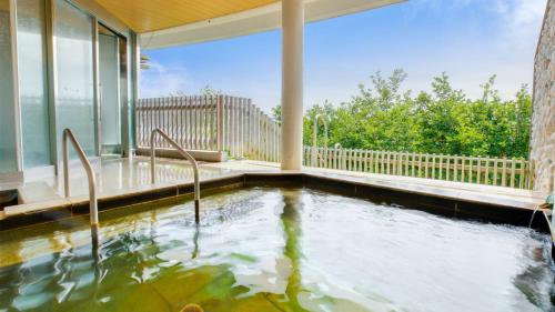 a swimming pool in the middle of a house at Kyukamura Nasu in Nasu