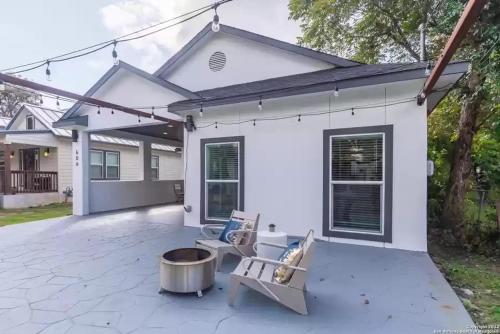 a patio with chairs and a fire pit in front of a house at Alamo City Haven in San Antonio