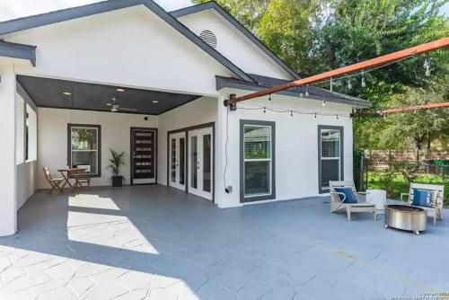 a white house with a patio at Alamo City Haven in San Antonio