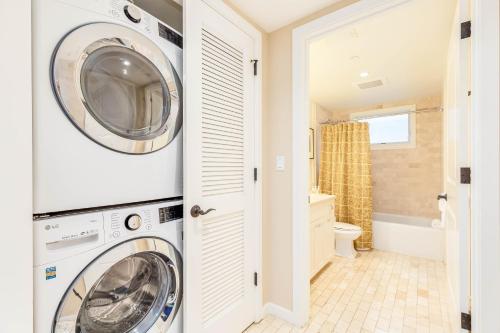 a washing machine and a washer and dryer in a bathroom at Turtle Bay Villas 205 in Kahuku