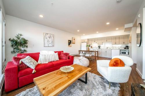a living room with a red couch and a table at Hot Arabaian NightsCornerPNHSEkingWifiU/G in Edmonton