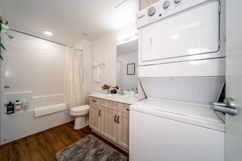 a white bathroom with a toilet and a sink at Hot Arabaian NightsCornerPNHSEkingWifiU/G in Edmonton