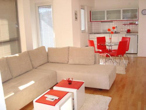 a living room with a couch and a table at Apartments Nela in Ohrid