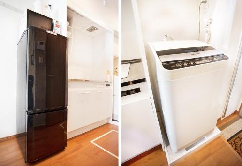 a kitchen with a black refrigerator and a stove at Ustay Kitakoiwa in Tokyo