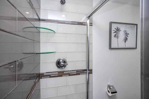 a bathroom with a shower with a glass door at #1 Stunning Ocean View completely remodeled luxury condo with huge balcony in Clearwater Beach