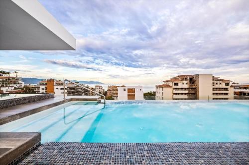 a large swimming pool on the roof of a building at Skyloftpv by LOFT268 in Puerto Vallarta