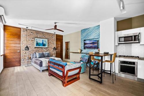 a living room with a bed and a kitchen at Skyloftpv by LOFT268 in Puerto Vallarta