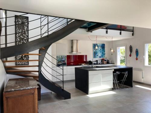 une cuisine avec un escalier en colimaçon dans une maison dans l'établissement Maison neuve moderne, proche plage Herlin, 5 chambres, jardin, terrasse, classement 3*, tout confort. - FR-1-418-194, à Bangor