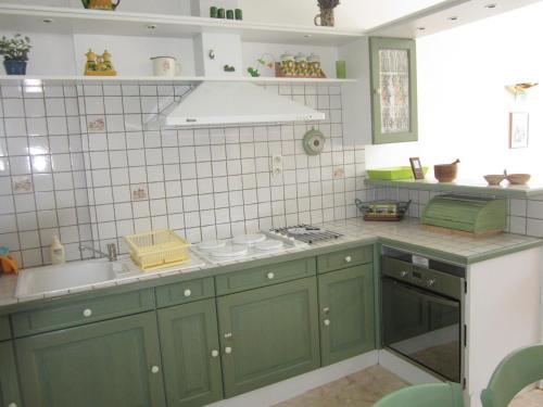 a kitchen with green cabinets and a sink at Appartement Villard-de-Lans, 3 pièces, 6 personnes - FR-1-689-108 in Villard-de-Lans