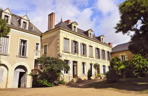 an old house with a turret on a street at La Grande Maison in Pas-de-Jeu