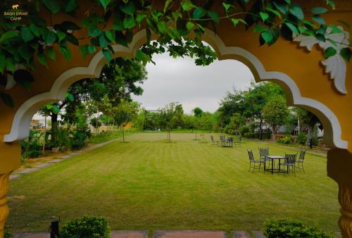 a view of a park with tables and chairs at Ranthambhore Bagh Dwar Camp in Khilchipur