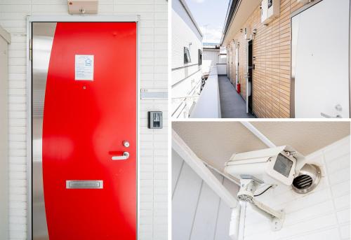 a red door and a security camera in a building at Ustay Kitakoiwa in Tokyo