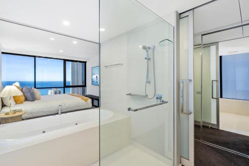a master bathroom with a tub and a glass shower stall at Circle on Cavill - Gclr in Gold Coast