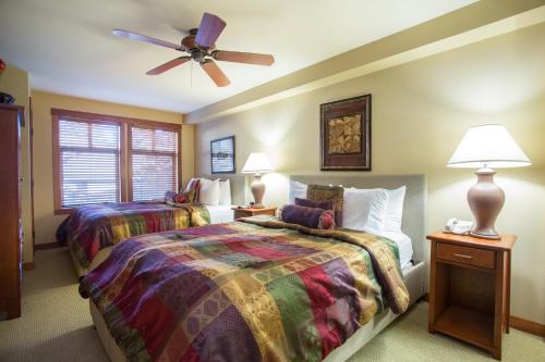 a bedroom with two beds and a ceiling fan at 1205A - One Bedroom Standard Eagle Springs West Hotel Room in Solitude