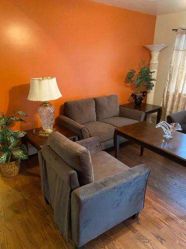 a living room with a couch and a table at Large 3-Bedrooms/2-Bath Apt, One Block to Train in Brooklyn