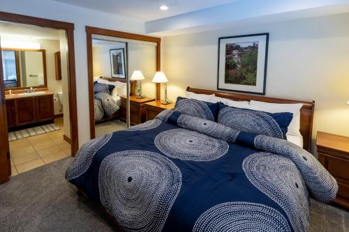 a bedroom with a bed and a bathroom with a mirror at 3201 - Two Bedroom Standard Powderhorn Lodge condo in Solitude