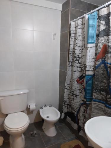 a bathroom with a toilet and a shower curtain at A 2 minutos caminando de la terminal. in Salta
