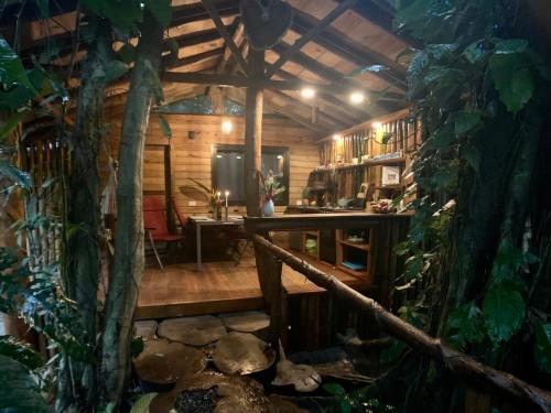 a room with a wooden house with a tree at Jungle Bluff Beach Paradise - Jungle House in Bocas del Toro