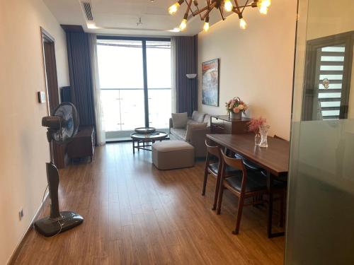 a living room with a dining table and a living room at Investland- Vinhomes Metropolis one, two, three, four bedrooms in Hanoi