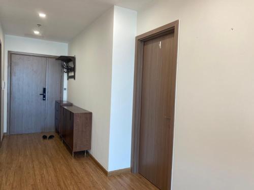 an empty room with a door and a wooden floor at Investland- Vinhomes Metropolis one, two, three, four bedrooms in Hanoi