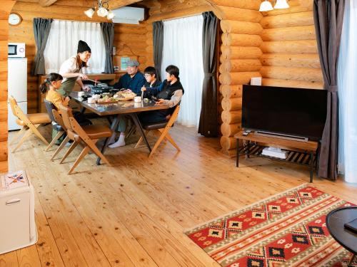 a group of people sitting around a table in a room at Matsue Forest Park in Matsue