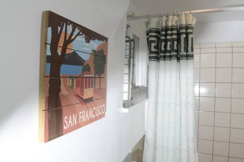 a bathroom with a painting on the wall and a mirror at Cozy Apartment near SFO in San Bruno